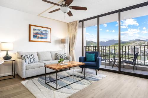 a living room with a couch and a table at Warm Aloha Vibes, Mountain Views, Short Walk to Beach, and Free Parking in Honolulu