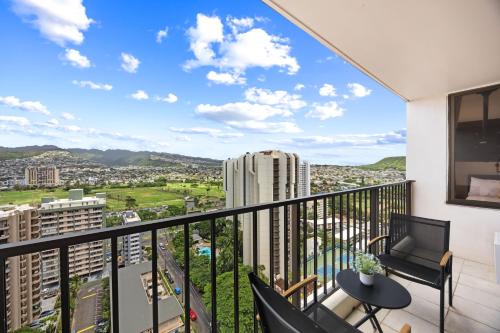 a balcony with a view of a city at Warm Aloha Vibes, Mountain Views, Short Walk to Beach, and Free Parking in Honolulu