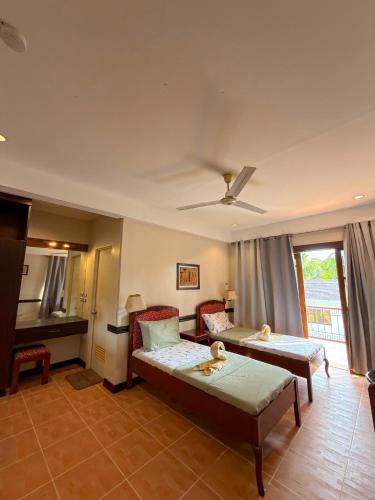 a living room with a bed and a table at Hotel Grand Luis in Dauis