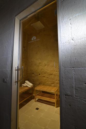 a door leading to a room with a bench in it at Le Dimore Dell' Idris in Matera