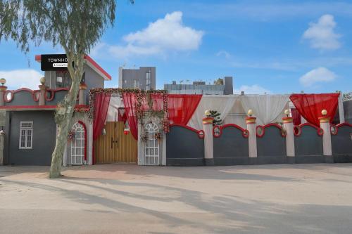 a building with red curtains on the side of it at OYO Townhouse Deva Road Lucknow in Lucknow