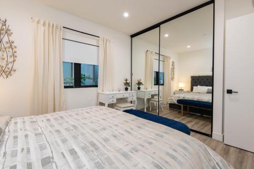 a bedroom with a large bed and a desk at Regency Modern Apartments in Glendale