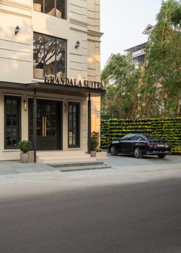 a black car parked in front of a building at Grandala Suites - A Boutique Hotel in Cochin