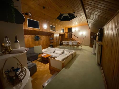 a living room with a white couch and a table at Péniche Amadeus conviviale et cosy , proche de Disney et de Paris in Torcy
