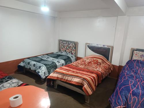 Llit o llits en una habitació de Posada Rossy