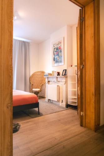 a bedroom with a bed and a desk and a table at Lyves in Liège