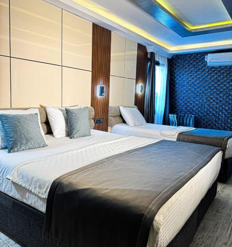 a hotel room with two beds and a couch at the Amara Hotel in Istanbul