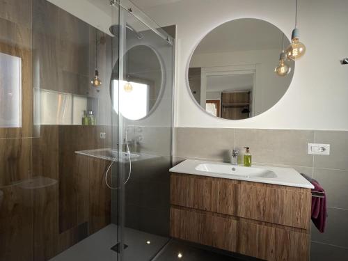 a bathroom with a sink and a mirror at B&B NALÙ in Arco