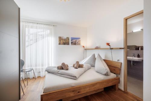a bed in a room with a mirror at Chasa AlpVista in Sent