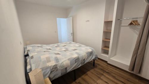 a small bedroom with a bed and a closet at Maison 4 personnes - Louargat in Louargat
