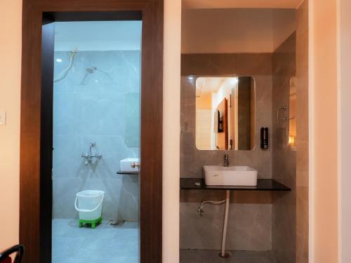 a bathroom with a sink and a mirror at Hotel Nirvvana Residency in Varanasi