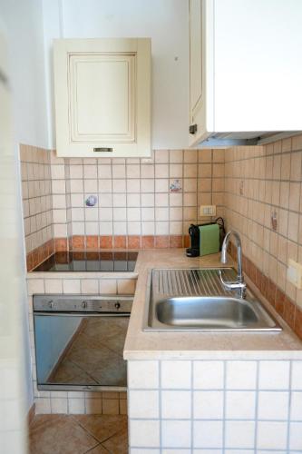 a kitchen with a sink and a counter top at Villette Calliope in Torre Specchia Ruggeri