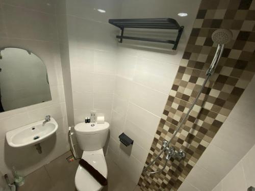 a bathroom with a toilet and a sink at Alton by Be rent in Jatingaleh