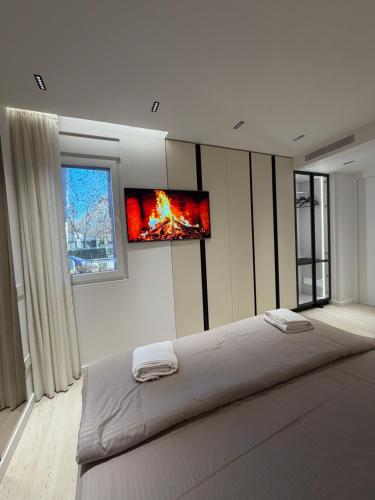 a bedroom with a bed with two monitors on the wall at RETLAV LUXURY Apartment in San Donato Milanese