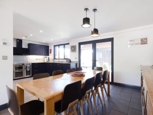 a kitchen and dining room with a wooden table and chairs at Rusty Barn in Gloucester