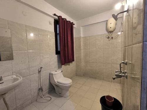 a bathroom with a toilet and a sink at Hotel Shreenathji Inn in Jāmb