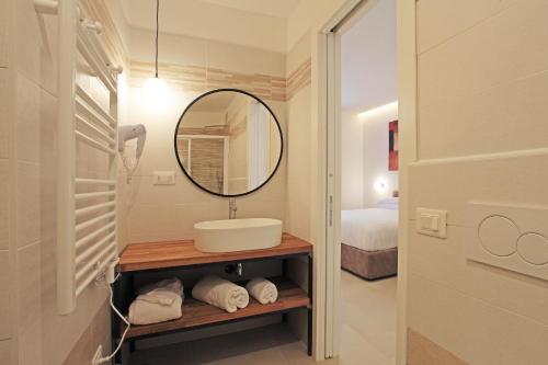 a bathroom with a sink and a mirror at Residenza del Centro in Fabriano