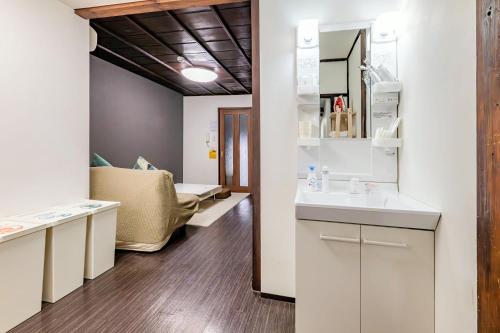a bathroom with a sink and a mirror at YAGARA TERRACE HOUSE OSAKA Room A in Osaka