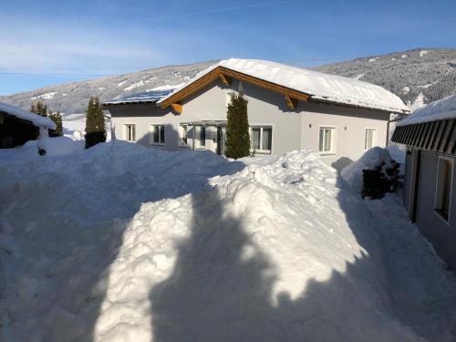 a house with a pile of snow in front of it at Ferienhaus Holiday in Radstadt