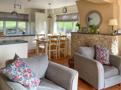 a living room with a couch and a dining room at Mimosa - Uk51224 in Swyre