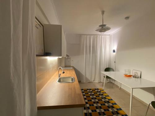 a kitchen with a sink and a counter top at RYB Colour Apartment in Patra