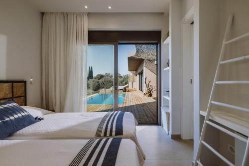 a bedroom with a bed and a view of a pool at Villa Morby in Paleros