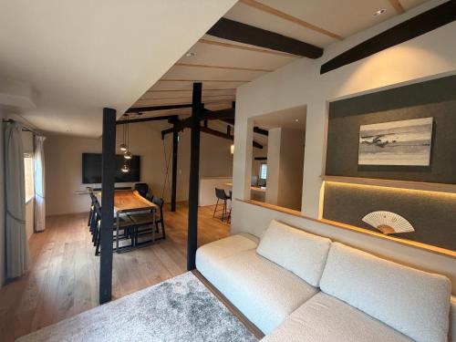 a living room with a couch and a bedroom at 耕 PRIVATE MAISON KOU - Vacation STAY in Kyoto