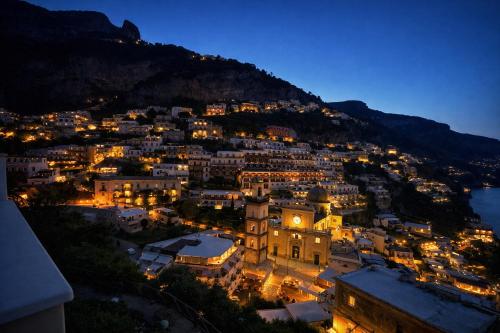 a view of a city at night at Hotiday Positano Sea View in Positano
