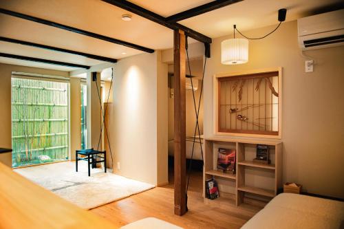 a living room with a bed and a window at 耕 PRIVATE MAISON KOU - Vacation STAY in Kyoto