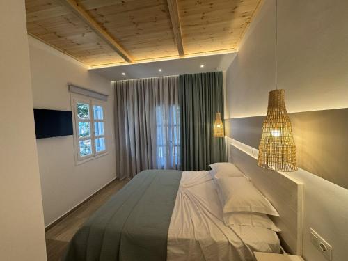 a bedroom with a large bed in a room at Patras Rooms est 1990 in Fournoi