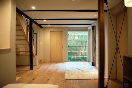 a living room with a staircase and a large window at 耕 PRIVATE MAISON KOU - Vacation STAY in Kyoto
