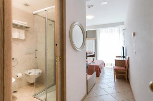 a bathroom with a shower and a toilet in a room at Hotel Excelsior in Cattolica
