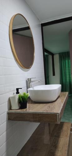 a bathroom with a large white sink and a mirror at LumaYan, Guesthouse and Cabin in Yan