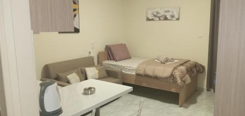 a small room with a bed and a table at elia patra apartment 2 in Patra