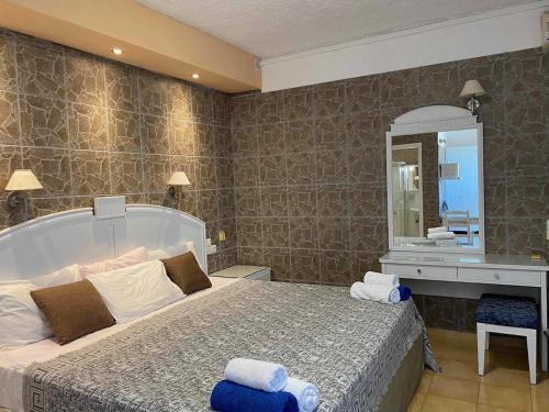 a bedroom with a large bed and a mirror at RESIDENTS IONIAN (BED AND BREAKFAST) in Argostoli