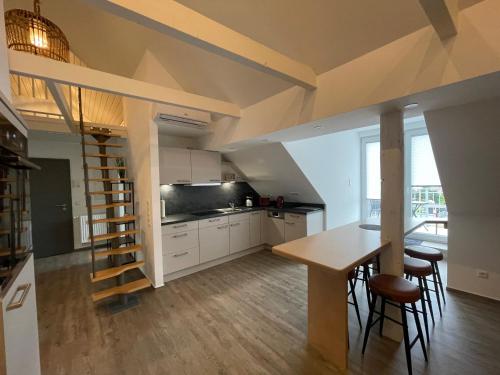 a kitchen with a dining table and a staircase in a room at B&K Immobilien GbR in Tangermünde