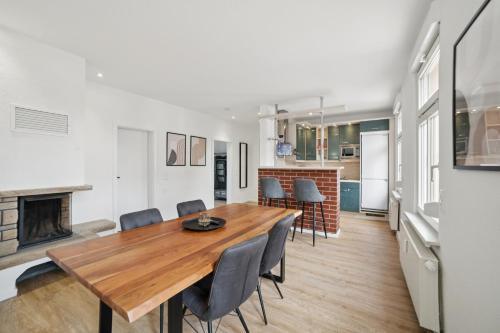 a dining room with a table and chairs and a fireplace at Apartment Alte Bäckerei in Zwenkau