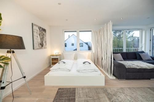 a living room with a couch and a table at Wellnessoase mit Sauna und Garten in Würzburg