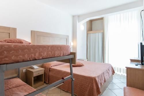 a hotel room with two beds and a balcony at Hotel Excelsior in Cattolica