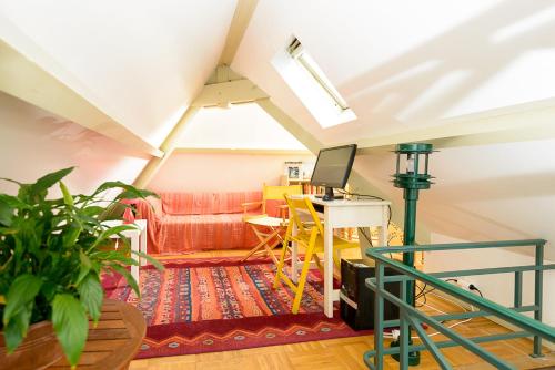 a living room with a desk and a couch at Le Logis d Orgeval in Orgeval
