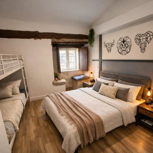 a bedroom with a bed and a bunk bed at Casa de Pedra in Melide