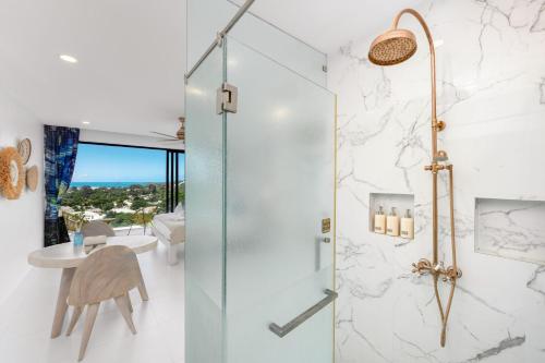 a bathroom with a shower with a glass door at Stunning X Space Villa Sea View Infinity Pool in Koh Samui