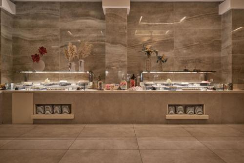 a kitchen with a counter with pots and flowers at Lindos Imperial Resort & Spa in Kiotari