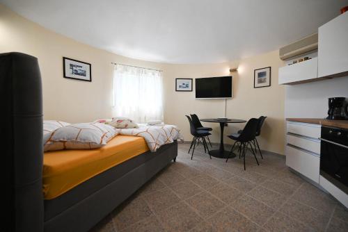 a bedroom with a bed and a table with chairs at Zminj Apartments in Žminj