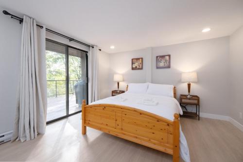a bedroom with a bed and a large window at Stylish Scenic Oasis 3-Bedroom Suite West Van in West Vancouver