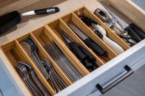 a drawer filled with utensils in a kitchen at Stylish Scenic Oasis 3-Bedroom Suite West Van in West Vancouver