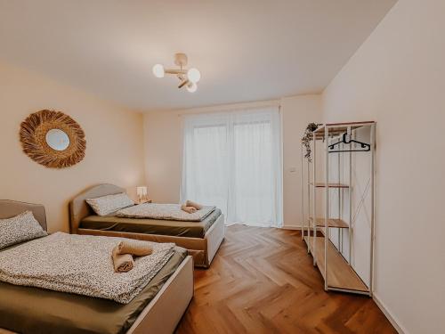 a room with two beds and a ladder in it at Batu Apartment in Viernheim