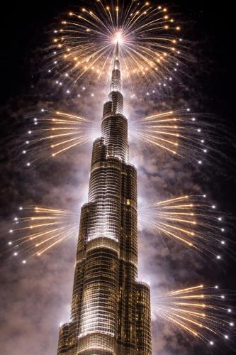 a fireworks display at the burj khalifa at night at Prime Luxury Private Room in Downtown near Burj Khalifa in Dubai
