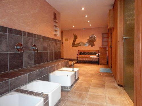 a bathroom with two sinks and two toilets at Land-gut-Hotel Zum alten Forsthaus - Aufladestation für Elektroautos in Hürtgenwald