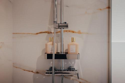 a bathroom with a soap dispenser on a wall at Atlantic Residence Pool & Ocean View in Câmara de Lobos